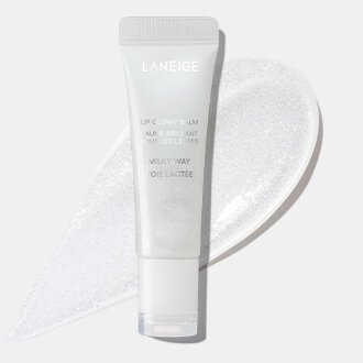 The Laneige Lip Glowy Balm Stardust Edition tube in the Milky Way shade is displayed with a sparkling white swatch, demonstrating its brilliant, glowy effect.