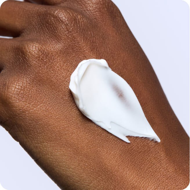 A generous dollop of Laneige's Cica Sleeping Mask is shown on a person's hand, highlighting its creamy texture and demonstrating its application for overnight skin recovery.