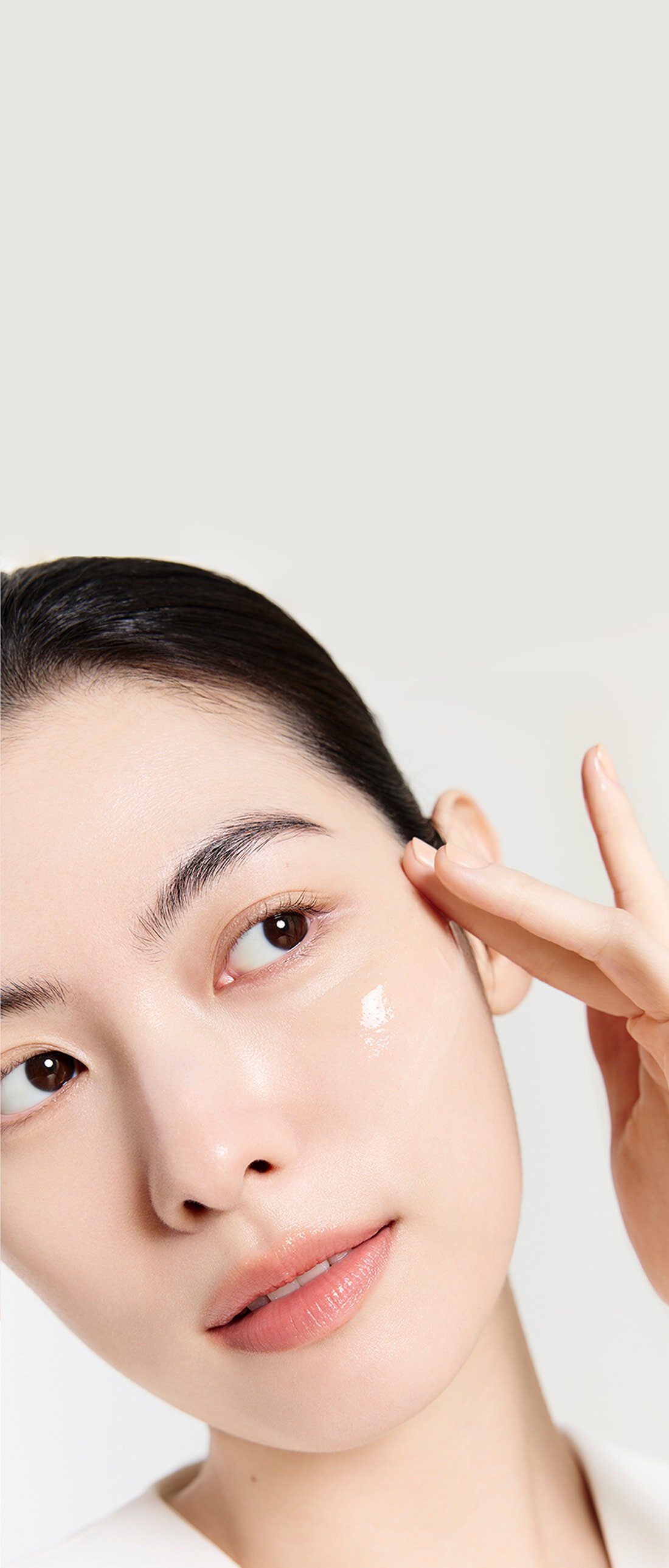 A model with a The Ultimate S Enriched Water on her face