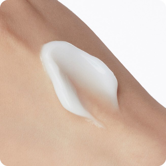 A generous dollop of LANEIGE's Water Sleeping Mask_EX rests on skin, showcasing its creamy, white texture and promising a well-slept, bright complexion.
