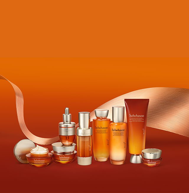 Several Sulwhasoo skincare products, including the Concentrated Ginseng Rejuvenating Cream, are elegantly arranged against a warm orange background, showcasing their luxurious textures and radiant amber hues, promising deeply hydrating and wrinkle-softening benefits for firmer, more radiant skin.