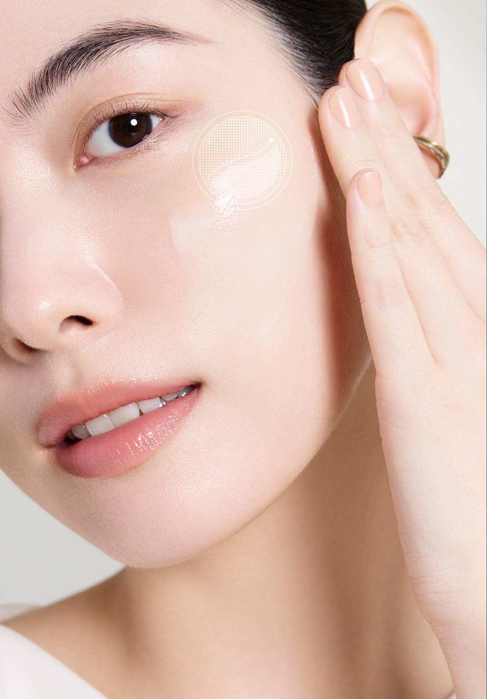 膚質柔嫩光澤的女性輕觸臉頰，臉上閃耀著塗抹後的亮澤精華，展現出雪花秀「極致臻秀能量修護安瓶」修復與賦能的卓越功效。