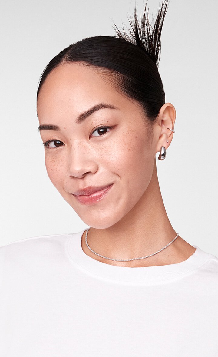 A model with minimal makeup and a fresh, natural look, suggesting the result of consistent skincare with Laneige Lip & Eye Sleeping Mask.