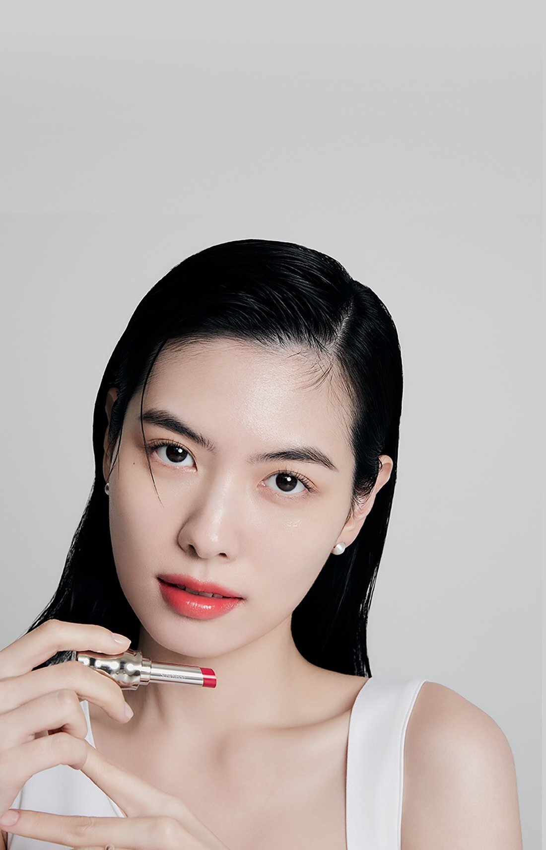 A model with Perfecting Lip Color NO.460 BERRY in hand