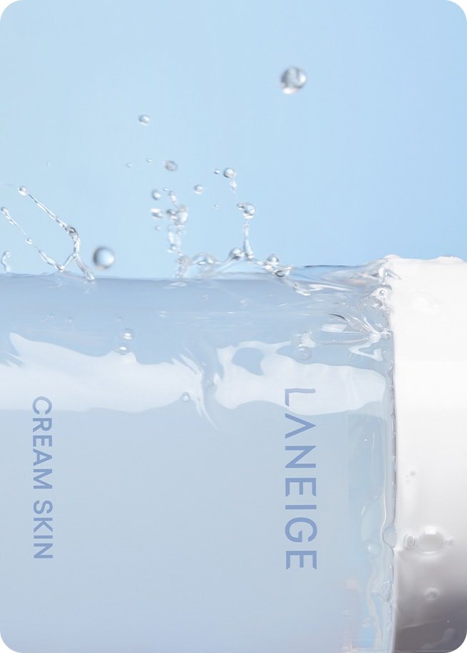 BTS Jin with glowing, dewy skin looking sideways, representing the soothing and moisturizing effect of the product