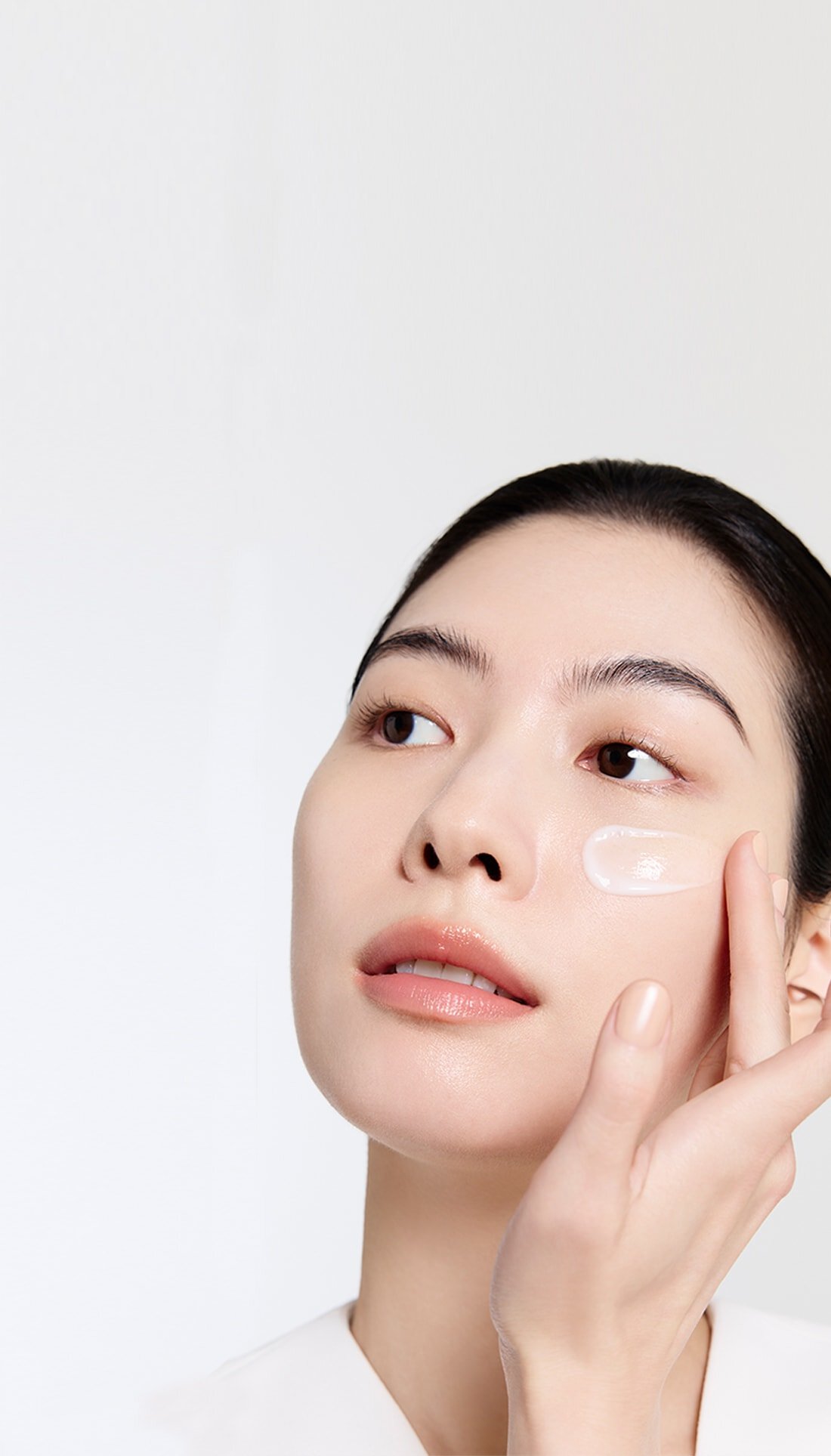 A model with a The Ultimate S Enriched Emulsion on her face