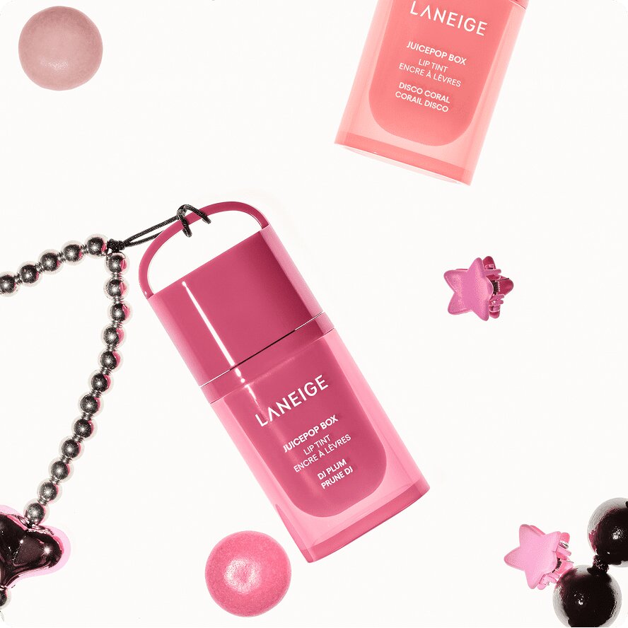Two LANEIGE Juicepop Box Lip Tints in DJ PLUM and DISCO CORAL shades, surrounded by colorful accessories