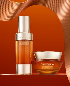 A bottle of Sulwhasoo Concentrated Ginseng Renewing Serum and a jar of Sulwhasoo Concentrated Ginseng Rejuvenating Cream sit together, showcasing their rich, amber-colored formulas designed to deeply hydrate and visibly firm skin for a radiant complexion.
