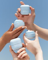Hands holding the Waterbank cream