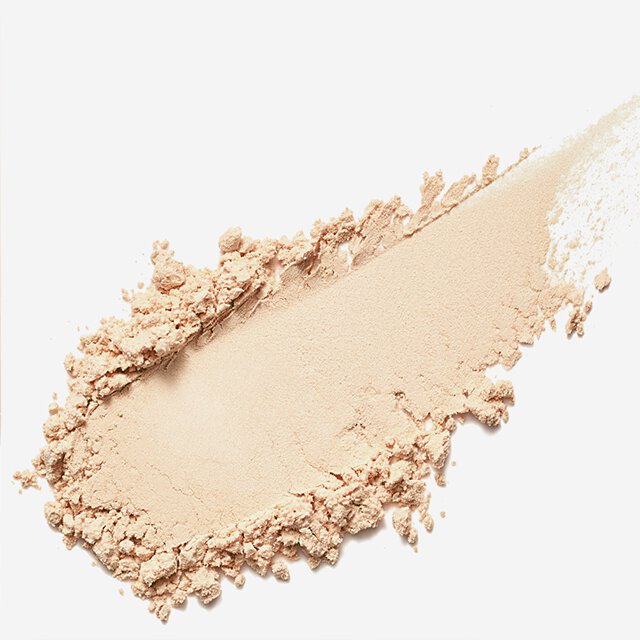 A diagonal swatch of fine, light beige powder with loose, crumbly edges demonstrates the ideal texture of Sulwhasoo's Perfecting Powder for a comfortable, skin-caring finish.