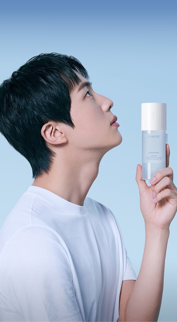 BTS member Jin holding CREAM SKIN ZINCPEP™ TONER & GEL MOISTURIZER product