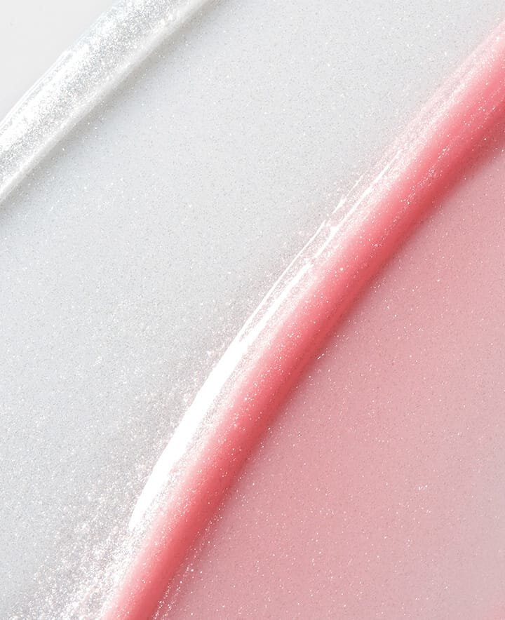 Thick, glistening swatches of an iridescent silver and a soft pink balm showcase the radiant sparkle of the Lip Glowy Balm Stardust Edition.